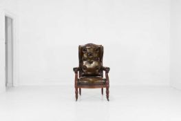 A carved mahogany and leather library armchair,