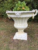 A pair of composite garden urns,