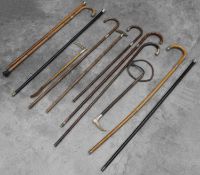 A collection of silver mounted walking sticks,