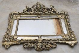 A large giltwood overmantel mirror,