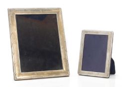 A graduated near pair of silver photography frames,
