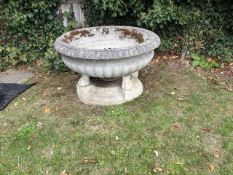 A low reconstituted garden urn,