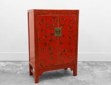 A Chinese red lacquered and painted marriage cupboard,