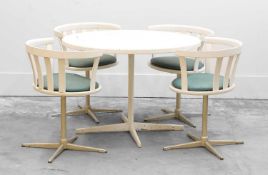 A modern circular table with matching chairs,