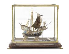 A white metal model of the 'Nao Victoria' in a display case,