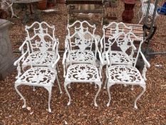 A cast iron garden table and six chairs,