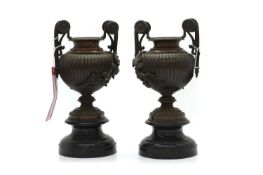 A pair of bronze two handled garniture urns,