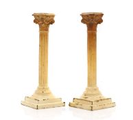 A pair of saltware Corinthian column candlesticks,