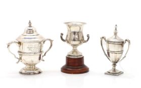 A group of three silver trophies,
