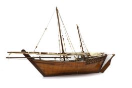 A scratch built wooden model of a sailing yacht,