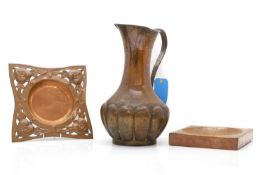 An Arts and Crafts copper jug and two dishes,