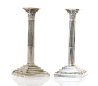 A pair of silver-plated Corinthian silver candlesticks,