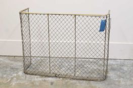 A brass and wirework fire guard,