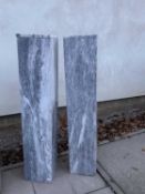 A pair of veined grey and white marble plinths,