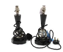 A pair of facet cut black and clear glass lamps,