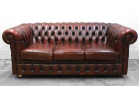 A red leather Chesterfield three seater sofa,