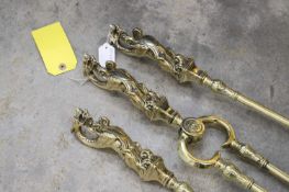 A set of brass fire tools,