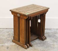 A nest of three teak ships tables,