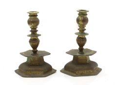 A pair of hexagonal bronze candlesticks,
