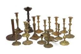 A large group of brass candlesticks,