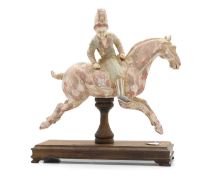 A Chinese painted pottery figure of a horse and rider,