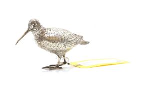 A silver model of a snipe,