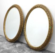 A pair of giltwood oval wall mirrors,