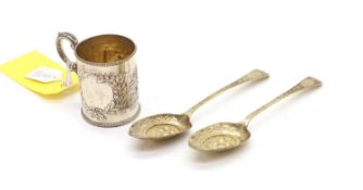 A silver christening mug,
