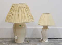 A near pair of cream glazed porcelain lamps,