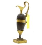 A patinated and gilt bronze ewer,