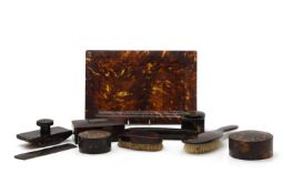 A collection of tortoiseshell dressing table items,