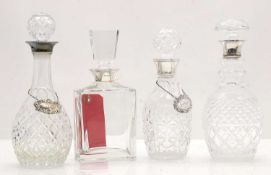 Four modern glass and silver mounted decanters,