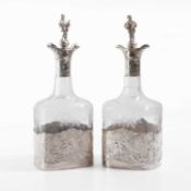 A pair of silver-mounted glass decanters,