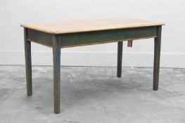 A modern kitchen table with limed oak top,