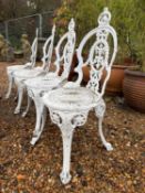 Four cast garden chairs,