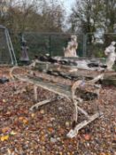 A wrought iron and teak garden bench,