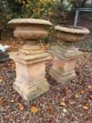 A pair of terracotta garden urns,
