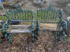 A pair of cast iron armchairs and a matching table,