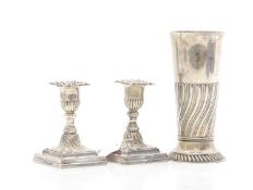 A pair of silver dwarf candlesticks,