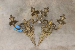 A pair of brass wall sconces,