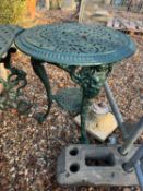 A cast iron table and a pair of chairs,