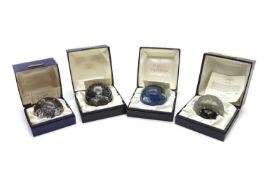 A collection of sixteen boxed Caithness glass paperweights