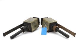 A pair of patinated black coach lamps,