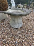 A large reconstituted garden urn,