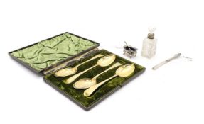 A cased set of four silver gilt serving spoons,