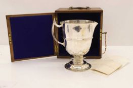 A large silver flagon,