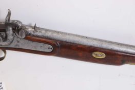 A percussion long gun with brass mountings,