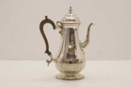 A silver coffee pot,