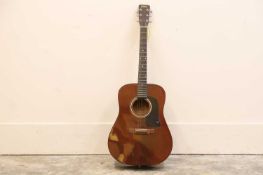 A Washburn six string acoustic guitar,