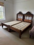 A pair of carved walnut single beds,